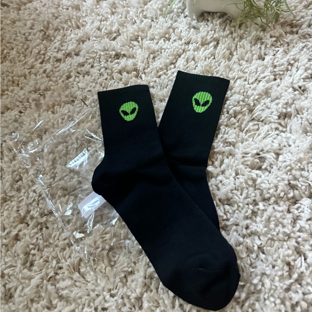 Brand new super cute pair of green alien socks. Size medium to large.
